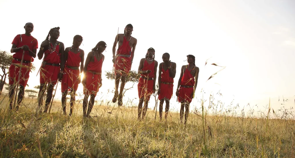 Masai warriors jumping in red dress