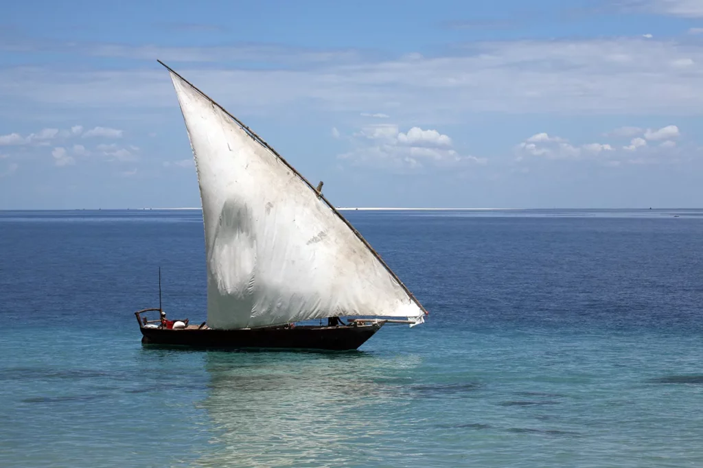 A traditional dhow saling boat on the blue sea of Zanzibar