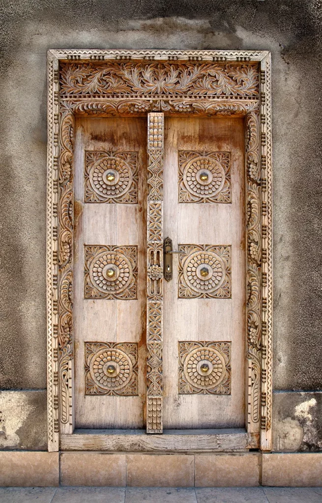 Close up of a wooden carved door in Stone Town Zanizibar