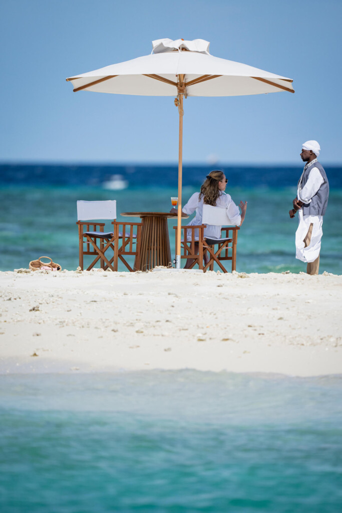 Fanjove Island, couple enjoys drinks on the beach