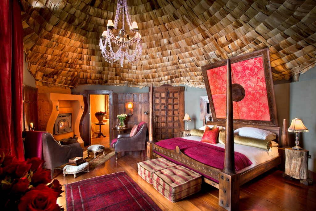 And Beyond Ngorongoro Crater Lodge, bedroom and four poster bed